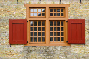 old red wooden window on brock wall